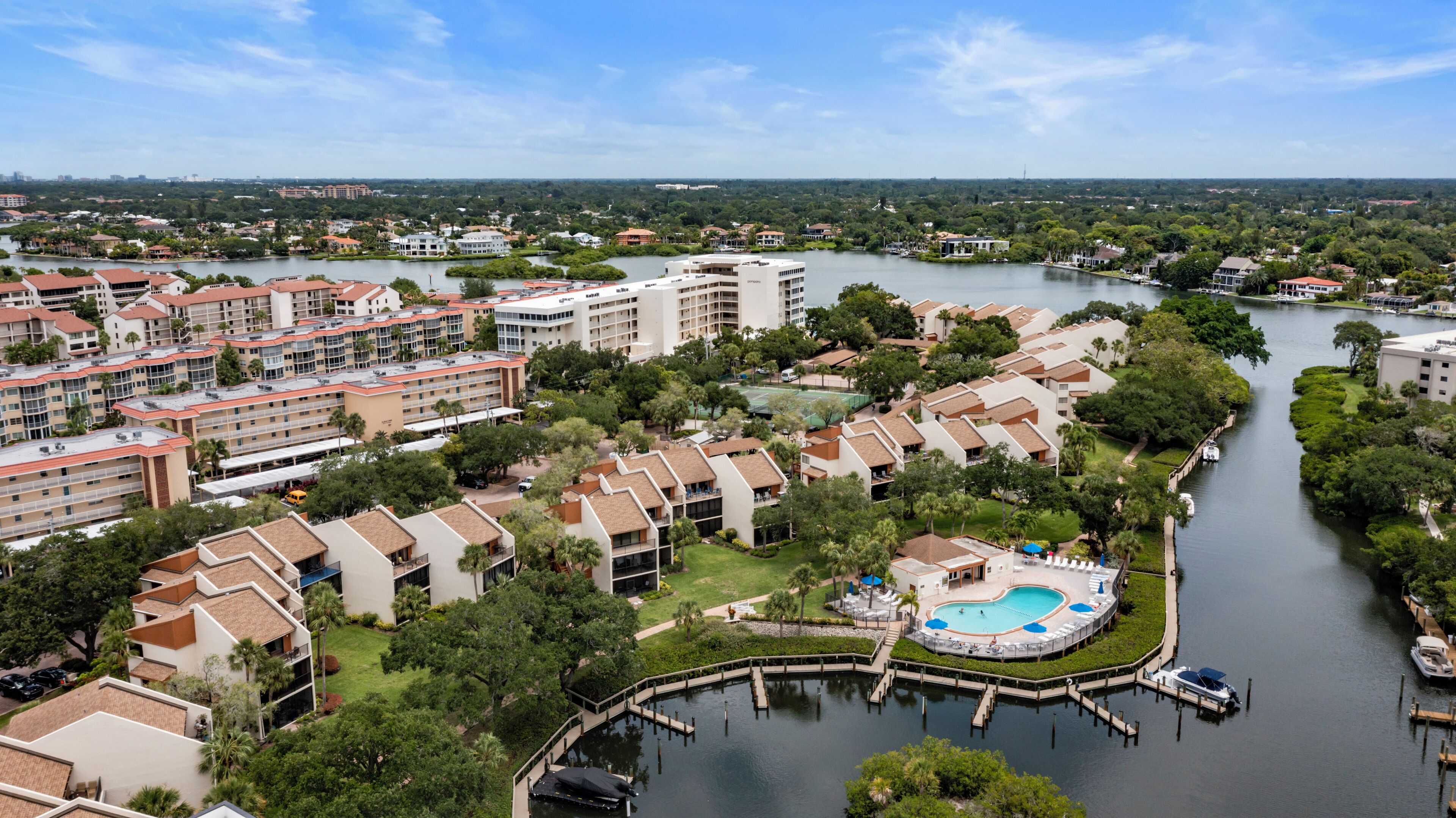 A resort with multiple buildings, a swimming pool, and a river.