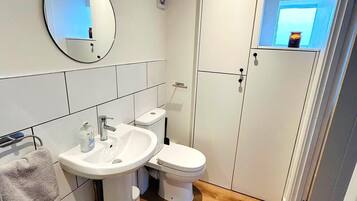 Shower, hair dryer, towels, toilet paper