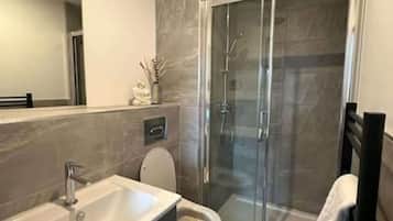 Shower, hair dryer, towels, shampoo