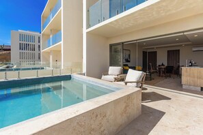 A modern hotel with a swimming pool, outdoor seating, and a view of the surrounding area. - Brisa Del Sol - Cabo Costa (Cabo San Lucas)