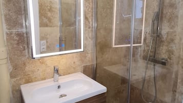 Shower, hair dryer, towels, toilet paper