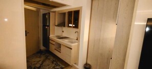 A compact bathroom with a sink, mirror, and cabinets. - Flamingo hotels & tours (Cairo)