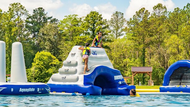 An inflatable water slide with a blue and white design, a person climbing it, and another person at the bottom. - 2 Bed/2 Bath - Pet Friendly, Sleeps 6 - 2 Bed/2 Bath - Pet Friendly, Sleeps 6 (Glen Saint Mary)