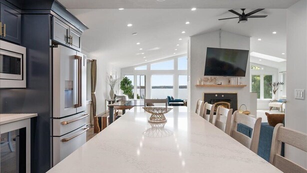 A modern kitchen with a large island, built-in appliances, and a flat-screen TV. - Oceanfront Acadia Views Arcade Game Room Pets Ok (Surry)