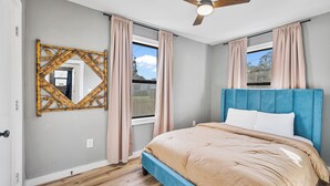 A bedroom with a bed, a ceiling fan, and two windows with curtains. - Quiet Milton Retreat Close to Downtown & Water! (Milton)