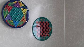 Un baño con inodoro, un dispensador de papel higiénico y dos placas decorativas en la pared.
