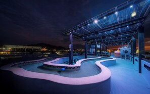 A rooftop pool area with a solar panel structure, a lounge area, and a sign reading 'Casa Del Toro'. - Your ideal stay in a modern apartment, comfort and style. (Barra de Navidad)