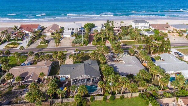 A coastal residential area with houses, a road, and a beach. - Sandcastle Harbor Pool & Firepit Steps to the Beach! (Ponce Inlet)
