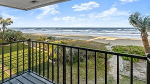 A balcony with a view of the ocean and beach. - Yellow Sunshine Oceanfront Townhouse, Private Balcony Unit #2 (Ponce Inlet)