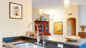 A kitchen with a large island, double sink, and pendant lighting. - Western Star Ahwatukee (Phoenix)