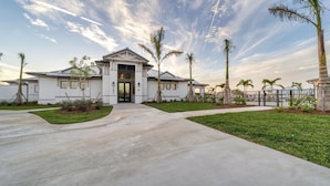 A modern two-story house with a front entrance, a driveway, and a well-maintained lawn. - Hlb14041-613 (Punta Gorda)