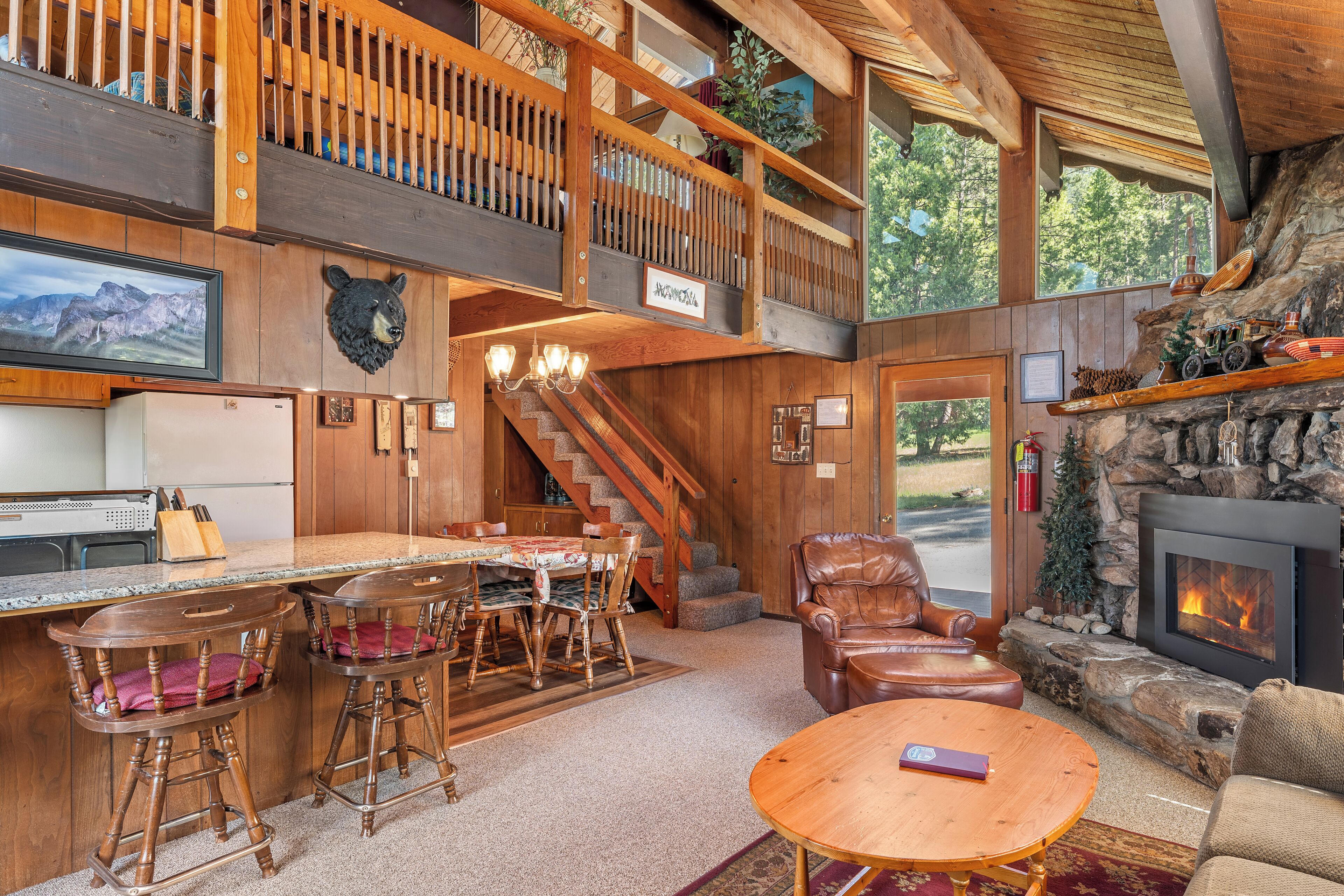 A spacious interior with a kitchen, dining area, and a fireplace.