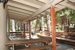 A covered outdoor seating area with wooden benches and a grill. - Altitude Adjustment (Yosemite National Park)
