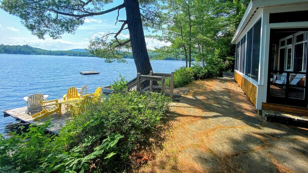 A lakeside cabin with a dock, outdoor seating, and a view of the lake. - 30fl Amazing Lake House 20 min From Bretton Woods Stunning Water Views! Bonus Room (Whitefield)