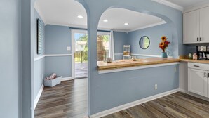 A kitchen with a wooden countertop, white cabinets, and a blue wall. - 516 Sweet Cherry Escape (Warrenton)