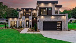 A modern two-story house with a garage, large windows, and a well-maintained lawn. - Shoreline on Stonemarker (Mooresville)