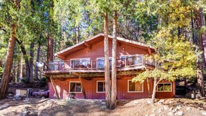 A cabin with a balcony, surrounded by trees. - Yosemite's Riverfront Retreat (Yosemite National Park)
