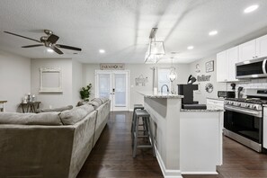 A modern kitchen with a central island, built-in oven, and a ceiling fan. - 10 Jill Lane, Cartersville (Cartersville)