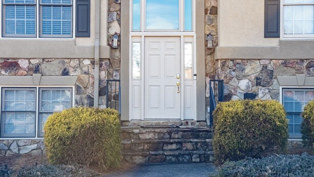A two-story building with a stone facade, a white front door, and a small step leading to the entrance. - 530 Waterford Drive, Cartersville (Cartersville)