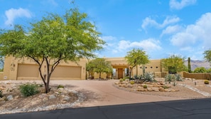 A desert-style building with a garage, surrounded by landscaped gardens and cacti. - Bellas Catalina Oasis (Tucson)