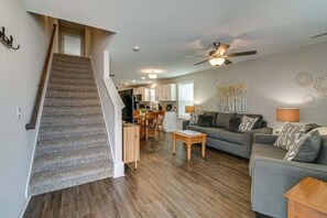 A spacious living area with a staircase, a dining area, and a kitchen. - Unit #B 1010 Franklin St (Clarksville)