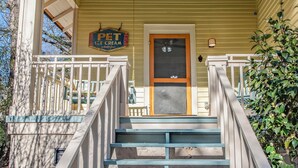 A porch with a sign reading "PET ICE CREAM" and a door. - Lenoir Cottage (Athens)