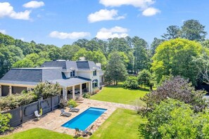 A two-story house with a covered patio and a swimming pool. - The Wexford French Chateau w/ Pool (Athens)