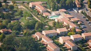 An aerial view of a residential area with multiple houses, a swimming pool, and a parking lot. - Amazing home in Montauroux with swimming pool (Montauroux)
