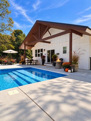 A swimming pool with a covered patio area, outdoor seating, and potted plants. - Private Pool Retreat- Fire Table + Country Escape in Cleveland TN (Cleveland)