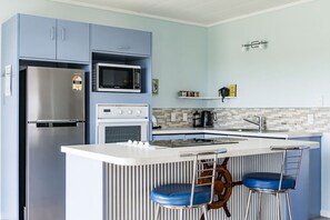 Fridge, microwave, oven, stovetop - Calypso Cottage • Bright Bach + Water View (Raglan)