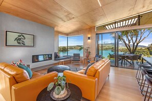 TV, fireplace - On Point House • Luxury Design • Water Views (Raglan)