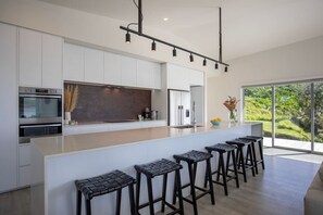 Fridge, microwave, oven, stovetop - Ocean Beach Retreat • Stylish Prime Beachfront (Raglan)