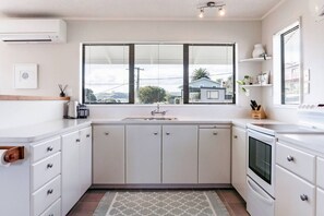 Coffee/tea maker, fridge, microwave, oven - Harbourside Cove • Views, Cosy + Peaceful (Raglan)