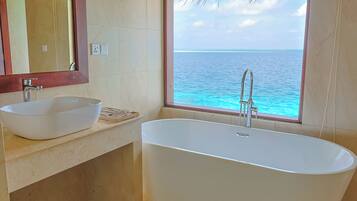 Separate tub and shower, hair dryer, slippers, towels