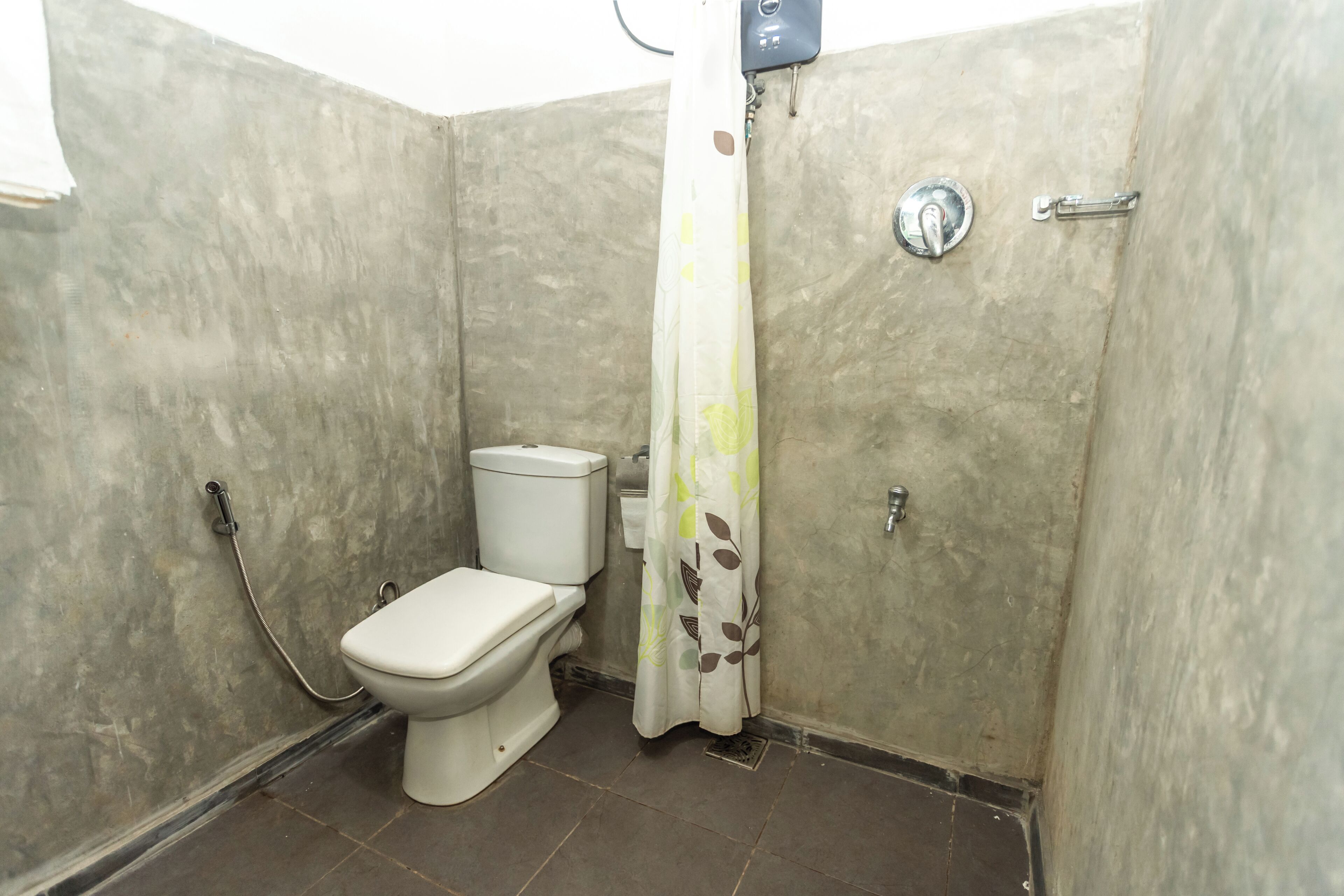 A small bathroom with a toilet, shower, and a curtain.