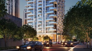 A high-rise building with multiple balconies, a modern design, and a well-lit facade. - The Crosby Luxury Corner 2BR/2BA Rooftop Pool & GYM | 2801 (Miami)