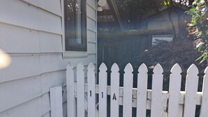 A white picket fence with a house in the background.