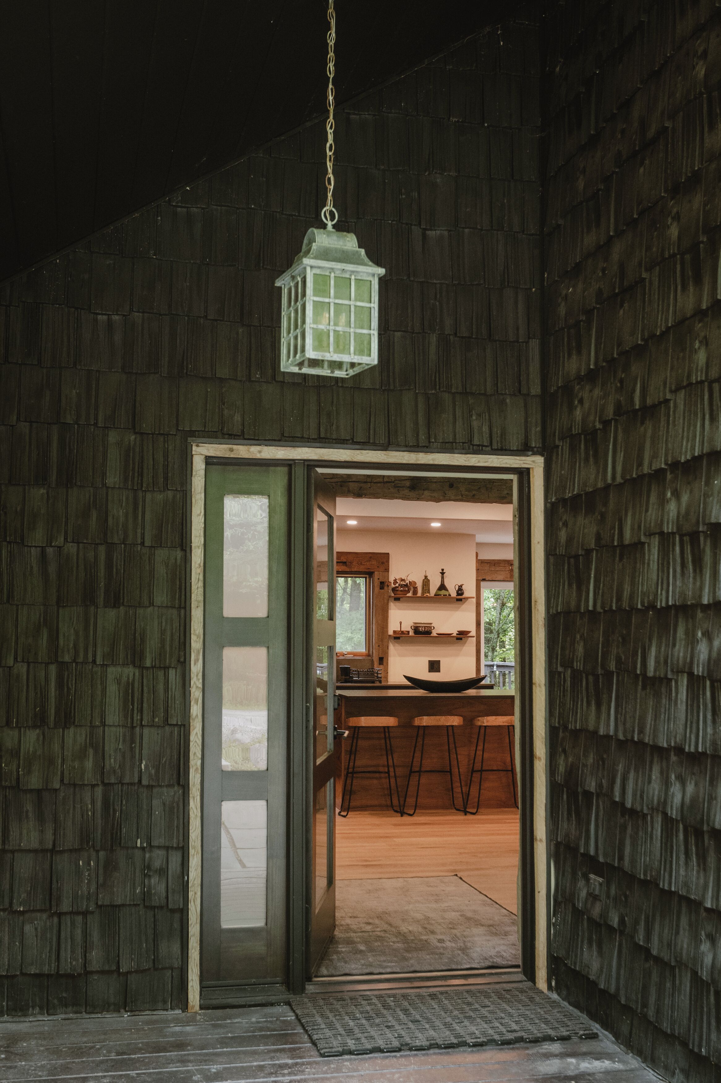 A wooden exterior with a door leading to an interior space.