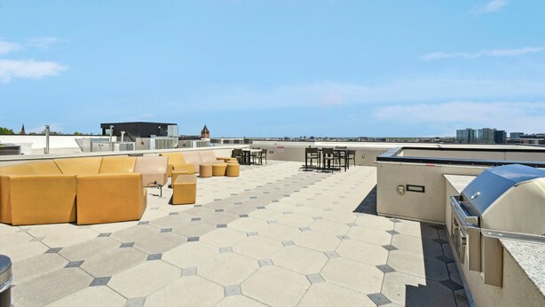 A rooftop terrace with hexagonal tiles, outdoor seating, and a barbecue area. - Golden Hour Designer Loft Espadin Lohi (Denver)