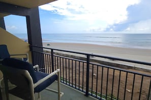 A balcony with a view of a beach. - The Maui Wowi Oceanfront Condo (Daytona Beach Shores)