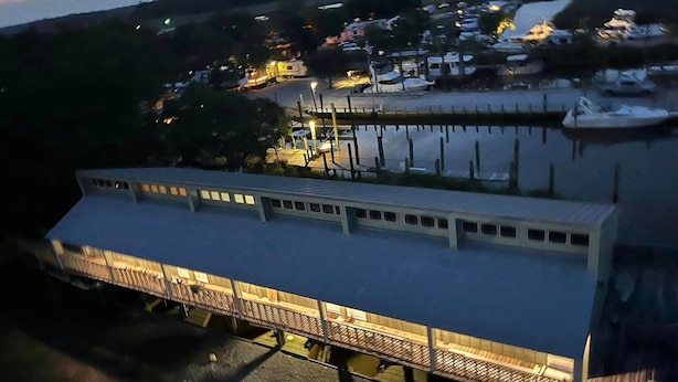 A large, multi-story building with a flat roof and a covered walkway.