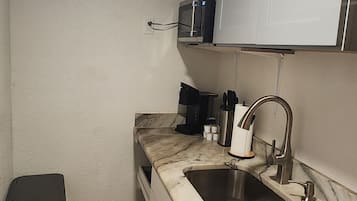 Fridge, microwave, coffee/tea maker, cookware/dishes/utensils