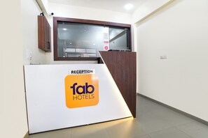 A reception desk with a sign for 'fab hotels' and a 'RECEPTION' label. - Fabhotel Nexus (Indore)