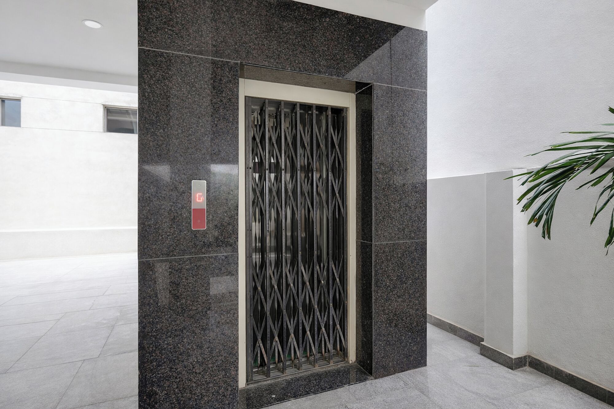 A modern elevator with a metallic interior and a digital display.