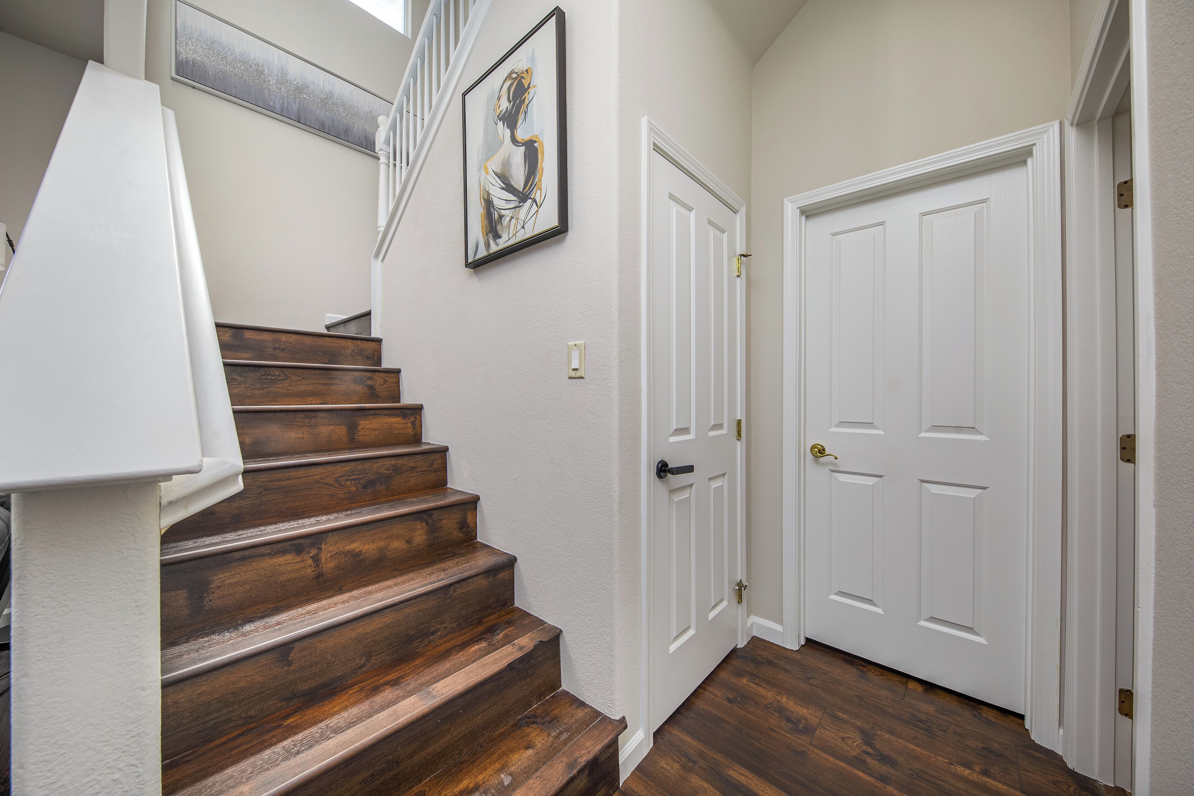 A staircase with wooden steps leading to a white door.