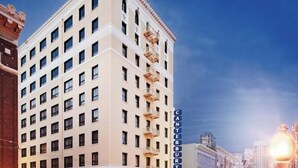 Un hotel de varios pisos con un diseño arquitectónico clásico, que presenta un letrero vertical llamativo con el nombre 'CANTERBURY' y el logotipo de 'WYNDHAM'.