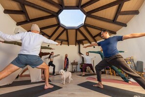 A group of people practicing yoga in a room with a wooden ceiling and a skylight. - Flutter Space Retreat | Yoga Dome | Pool (Yucca Valley)