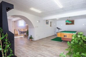 A spacious room with a billiards table, a dining area, and a green plant. - Holiday Home Cadjo With Private Pool (Brtonigla)