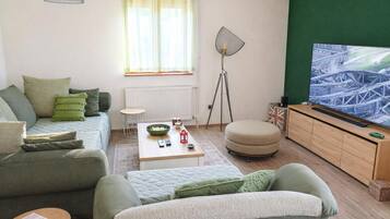 Family House, Multiple Bedrooms, 2 Bathrooms (Green View Holiday Home With Pool) | Living area | 21-inch Smart TV with digital channels, fireplace, video game console