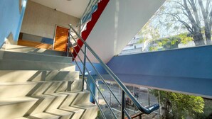 A modern staircase with a glass railing, leading to an upper floor. - Veerakit Grand Hotel Udon Thani (Udon Thani)